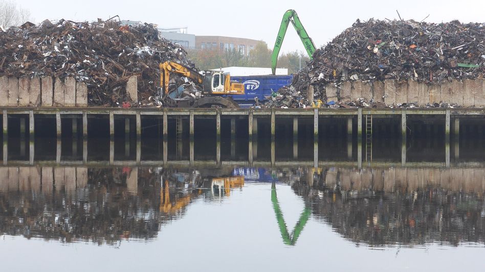 Shredded ferrous scrap piled beside a loading ramp at a Midwest yard